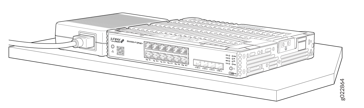 Juniper Networks EX4100-F-12P switch with multiple Ethernet ports and a connected power cable on a flat surface.